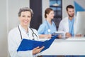 Portrait of happy female doctor holding medical reports Royalty Free Stock Photo