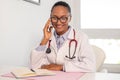 Portrait of happy female doctor talking on mobile phone Royalty Free Stock Photo