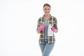 Portrait of happy female doing house duties wearing rubber gloves and holding cleaning equipment. Cheerful look. Hygiene, cleaning