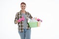 Portrait of happy female doing house duties wearing rubber gloves and holding cleaning equipment. Cheerful look. Hygiene, cleaning Royalty Free Stock Photo