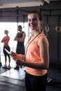 Portrait of happy female fitness instructor holding clipboard in gym Royalty Free Stock Photo