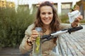 Portrait of happy female in overall sitting outside in city Royalty Free Stock Photo