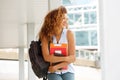 Happy female student laughing outside with books Royalty Free Stock Photo