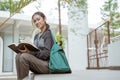 Portrait of happy female student looking camera holding book Royalty Free Stock Photo