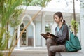 Portrait of happy female student reading holding book Royalty Free Stock Photo