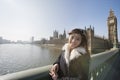 Portrait of happy female tourist visiting Big Ben at London, England, UK Royalty Free Stock Photo