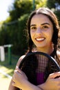 Portrait of happy fit caucasian woman holding tennis racket on outdoor tennis court, copy space Royalty Free Stock Photo