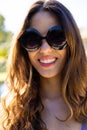 Portrait of happy fit caucasian woman wearing sunglasses smiling in sunny garden Royalty Free Stock Photo