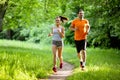 Portrait of happy fit people running together ourdoors. Couple sport healthy lifetsyle concept