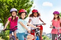 Happy boy riding bicycle with friends in summer Royalty Free Stock Photo