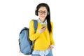 Portrait of a happy friendly casual girl student asian in glasses with backpack holding mobile phone isolated over white