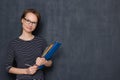 Portrait of happy friendly girl holding folders and pen in hands Royalty Free Stock Photo