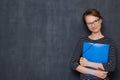 Portrait of happy friendly girl smiling and holding folder and pen Royalty Free Stock Photo