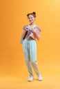 Portrait of a happy friendly girl student with backpack holding books Royalty Free Stock Photo