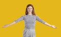 Portrait of a happy, friendly woman smiling and spreading her arms wide open for a hug Royalty Free Stock Photo
