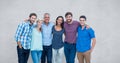 Portrait of happy friends standing against gray background Royalty Free Stock Photo