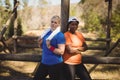 Portrait of happy friends standing with arms crossed during obstacle course Royalty Free Stock Photo