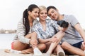 Portrait of happy friends taking photo of themselves on beach. Royalty Free Stock Photo