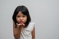 Portrait of happy and funny Asian child girl on white background, a child looking at camera. Preschool kid dreaming fill with Royalty Free Stock Photo