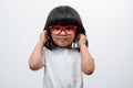 Portrait of happy and funny Asian child girl on white background, a child looking at camera hand gesture. Preschool kid dreaming Royalty Free Stock Photo