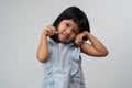 Portrait of happy and funny Asian child girl on white background, a child looking at camera hand gesture. Preschool kid dreaming Royalty Free Stock Photo