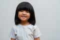 Portrait of happy and funny Asian child girl on white background, a child looking at camera. Preschool kid dreaming fill with Royalty Free Stock Photo