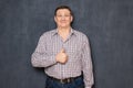 Portrait of happy funny man raising thumb up in like gesture Royalty Free Stock Photo