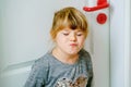 Portrait of happy funny smiling toddler girl indoors. Little preschool child with blond hairs looking at the camera. Royalty Free Stock Photo