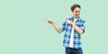 Portrait of happy funny young man in casual blue checkered shirt and headband standing with toothy smile satisfied face and