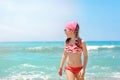 Portrait of a happy girl on the background of the turquoise sea. Beach family vacation concept Royalty Free Stock Photo