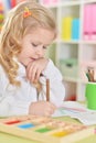 Portrait of a happy girl drawing with colorful pencils Royalty Free Stock Photo