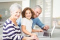 Portrait of happy girl with grandparents using laptop Royalty Free Stock Photo