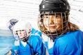 Portrait of happy girl in ice hockey uniform