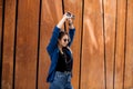 Portrait of a happy girl listening music on line with headphones from a smartphone in the street in a summer sunny day. Woman list Royalty Free Stock Photo