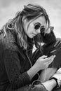 Portrait of a happy girl listening music on line with headphones from a smartphone in the street in a summer sunny day. Woman list Royalty Free Stock Photo