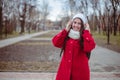 Portrait of a happy girl listening music on line with wireless headphones from a smartphone in hat Royalty Free Stock Photo