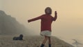 Happy girl looking at camera. Fashionable woman posing on beach at sunrise Royalty Free Stock Photo