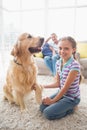 Portrait of happy girl playing with dog at home Royalty Free Stock Photo