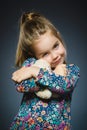 Portrait of happy girl playing with Toy dog isolated on gray Royalty Free Stock Photo