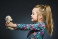 Portrait of happy girl playing with Toy dog isolated on gray Royalty Free Stock Photo