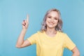 Portrait of happy girl pointing something by finger isolated. Royalty Free Stock Photo