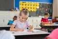 Smiling school girl writing Royalty Free Stock Photo