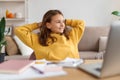 Portrait of happy girl sitting at a table with a laptop