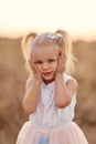 Portrait of happy girl smeared with colored powder. little girl with two tails Royalty Free Stock Photo