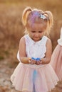 Portrait of happy girl smeared with colored powder. little girl with two tails Royalty Free Stock Photo