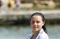 Portrait of girl smiling on the beach wrapped in a towel Royalty Free Stock Photo