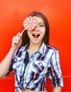 Portrait happy girl with sweet caramel lollipop having fun