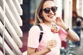 Outgoing lady eating delicious sweet