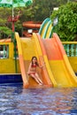 Portrait of a happy girl on water slide Royalty Free Stock Photo