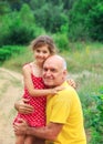 Portrait of  granddad and grandaughter playing at the park Royalty Free Stock Photo